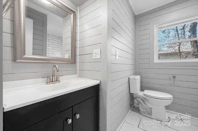 a bathroom with a sink toilet and window