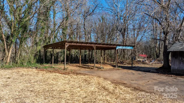 a backyard of a house with barbeque oven