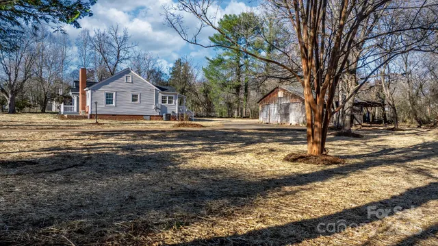a view of a house with a yard covered with snow