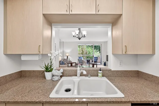 a kitchen with kitchen island a counter top space cabinets and stainless steel appliances