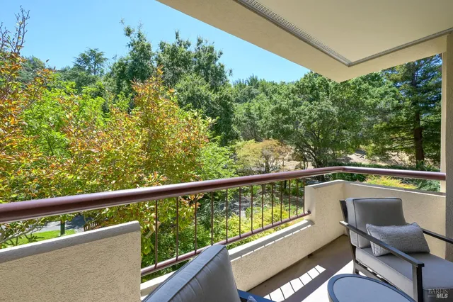 a view of a chair and table in the balcony