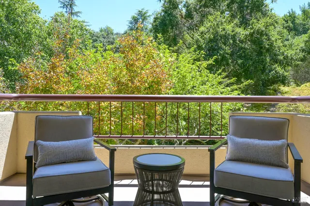 a view of a chair and table in the balcony
