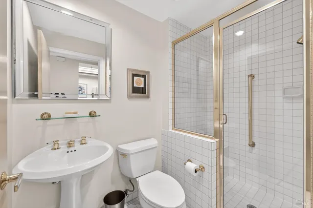 a bathroom with a sink toilet and shower