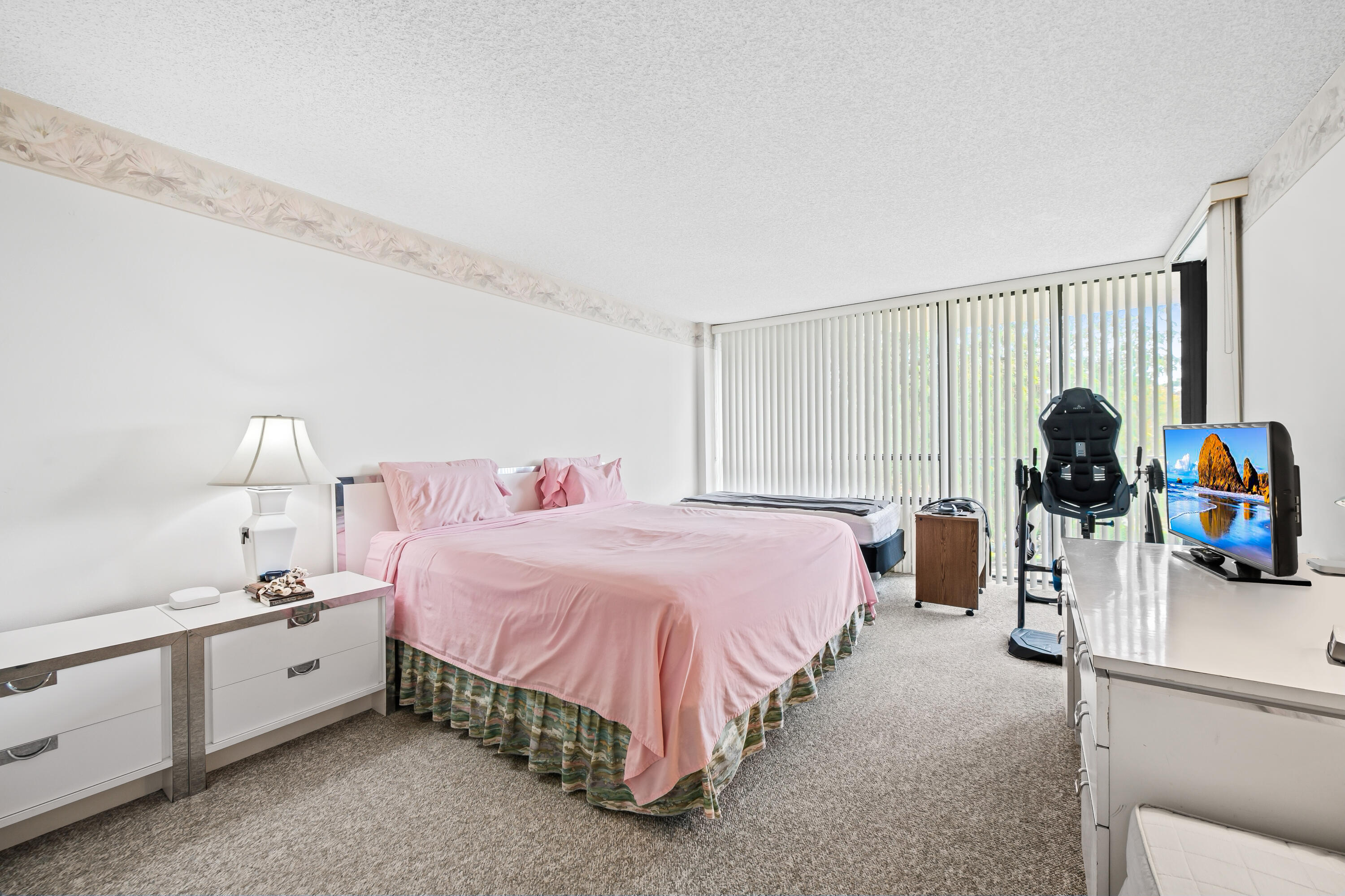 799 Jeffery Street, Unit 4050 Boca Raton, FL 33487 - Photo 17 of 39 a spacious bedroom with a bed and a couch