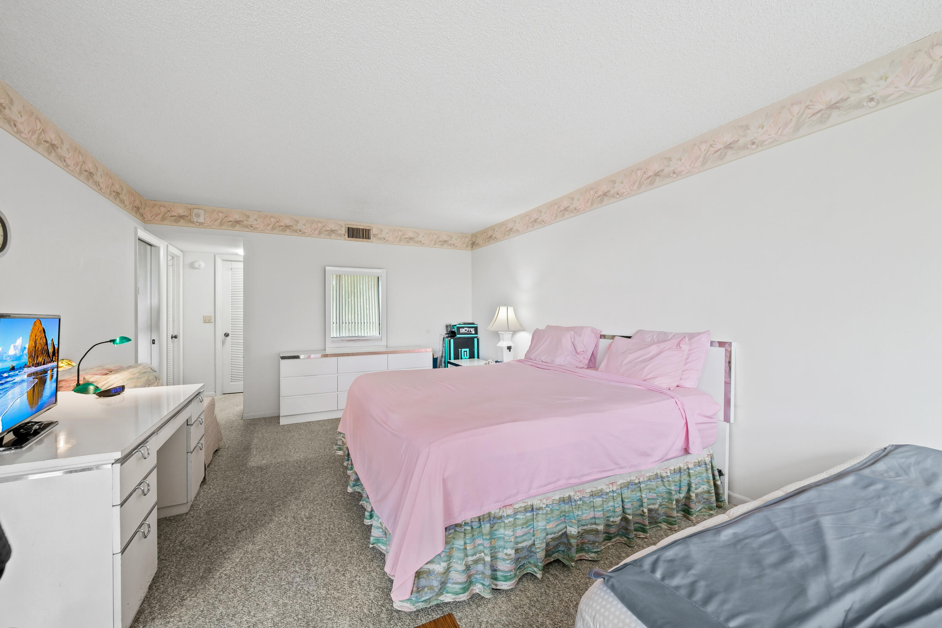 799 Jeffery Street, Unit 4050 Boca Raton, FL 33487 - Photo 18 of 39 a bedroom with a bed and a couch