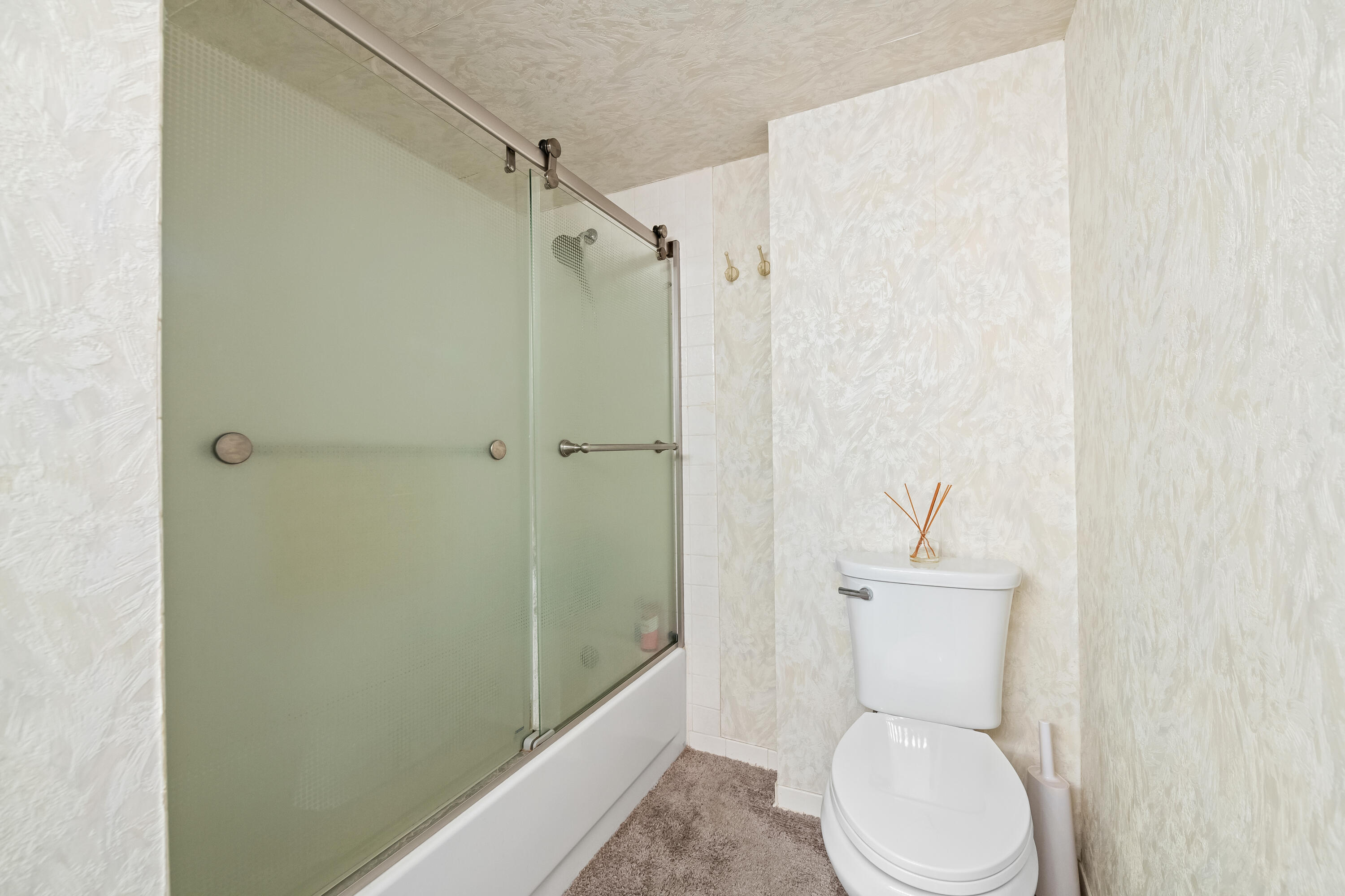 799 Jeffery Street, Unit 4050 Boca Raton, FL 33487 - Photo 22 of 39 a white toilet sitting next to a bathroom sink