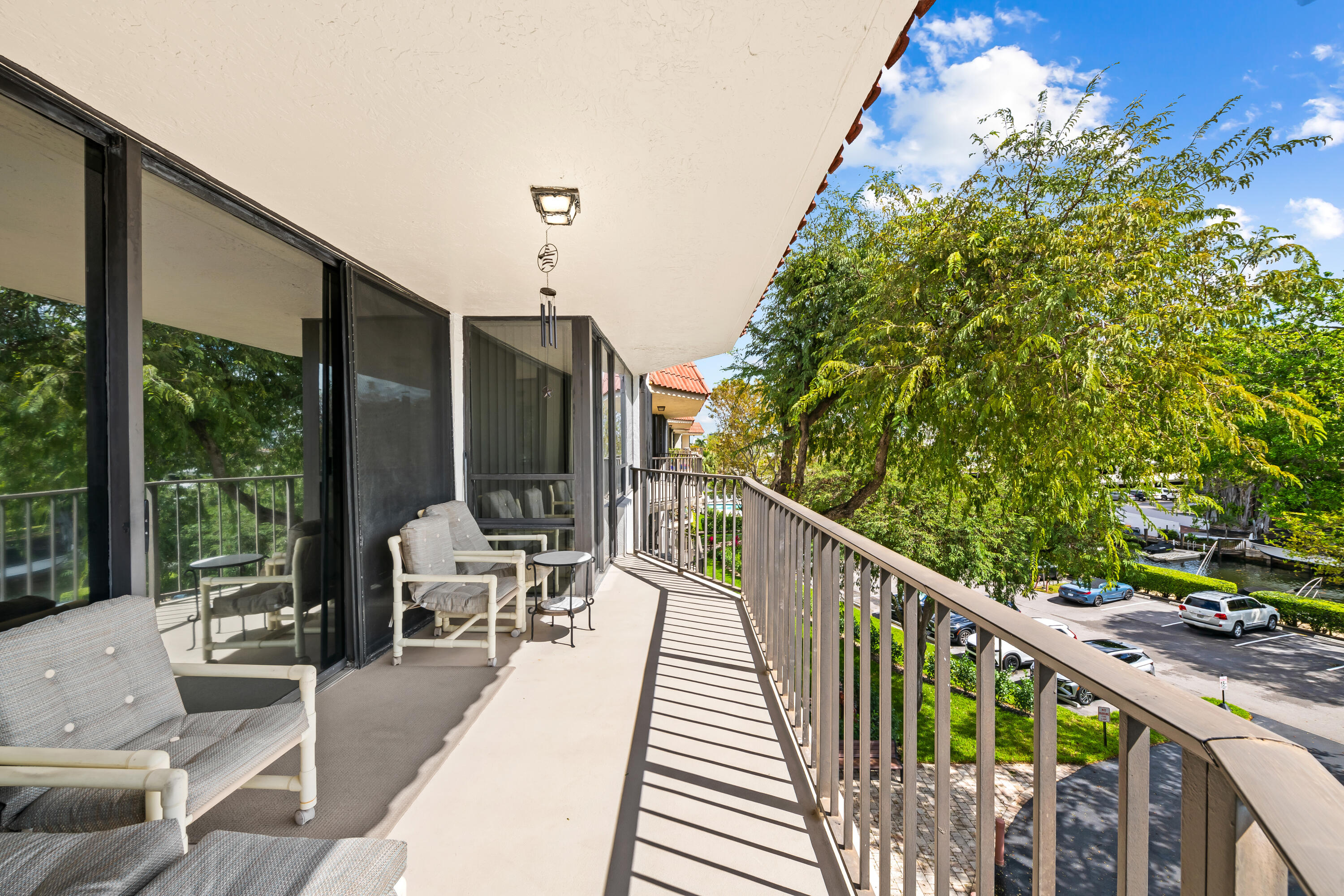 799 Jeffery Street, Unit 4050 Boca Raton, FL 33487 - Photo 4 of 39 a balcony with wooden floor and outdoor seating