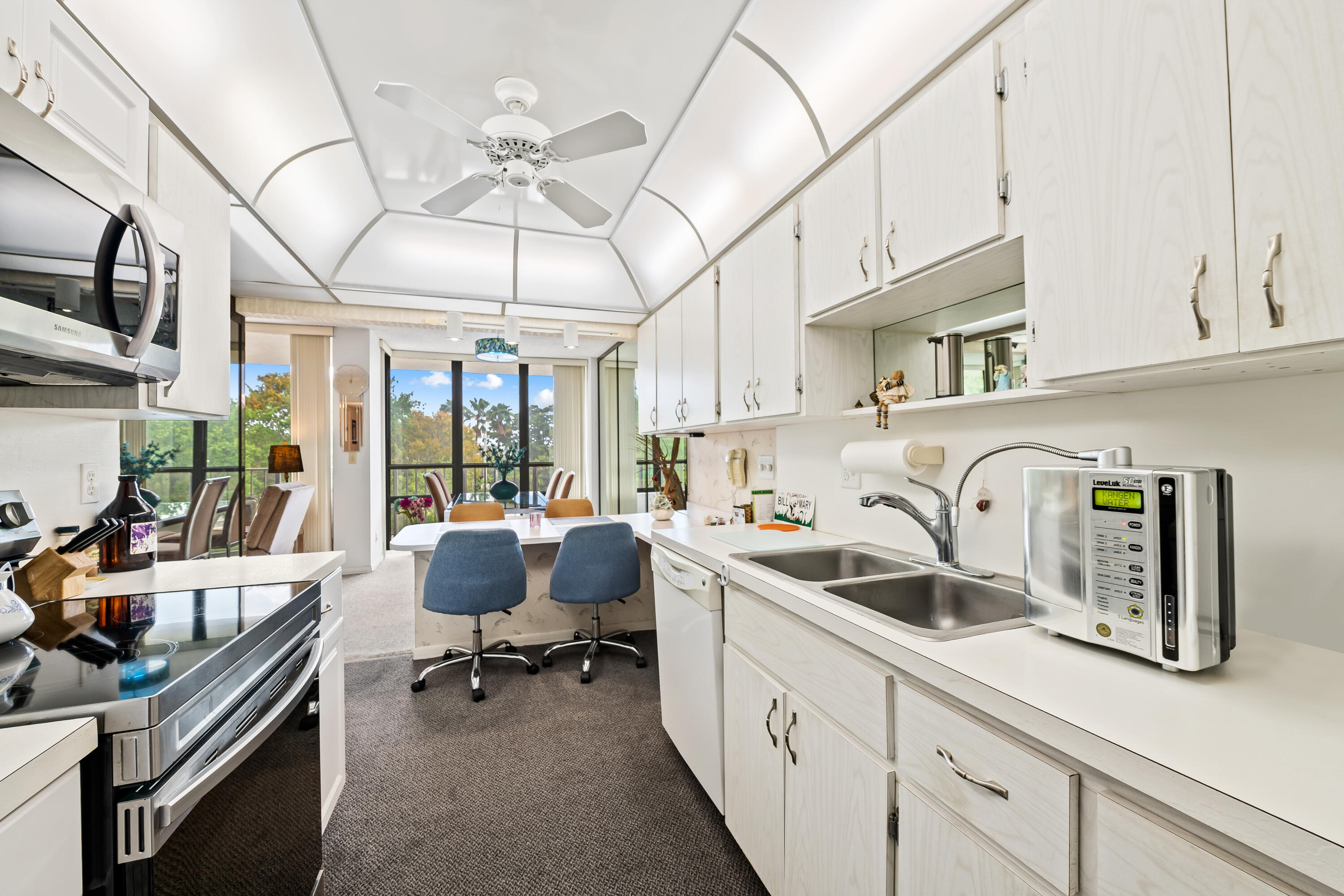 799 Jeffery Street, Unit 4050 Boca Raton, FL 33487 - Photo 8 of 39 a kitchen with stainless steel appliances granite countertop a sink and cabinets