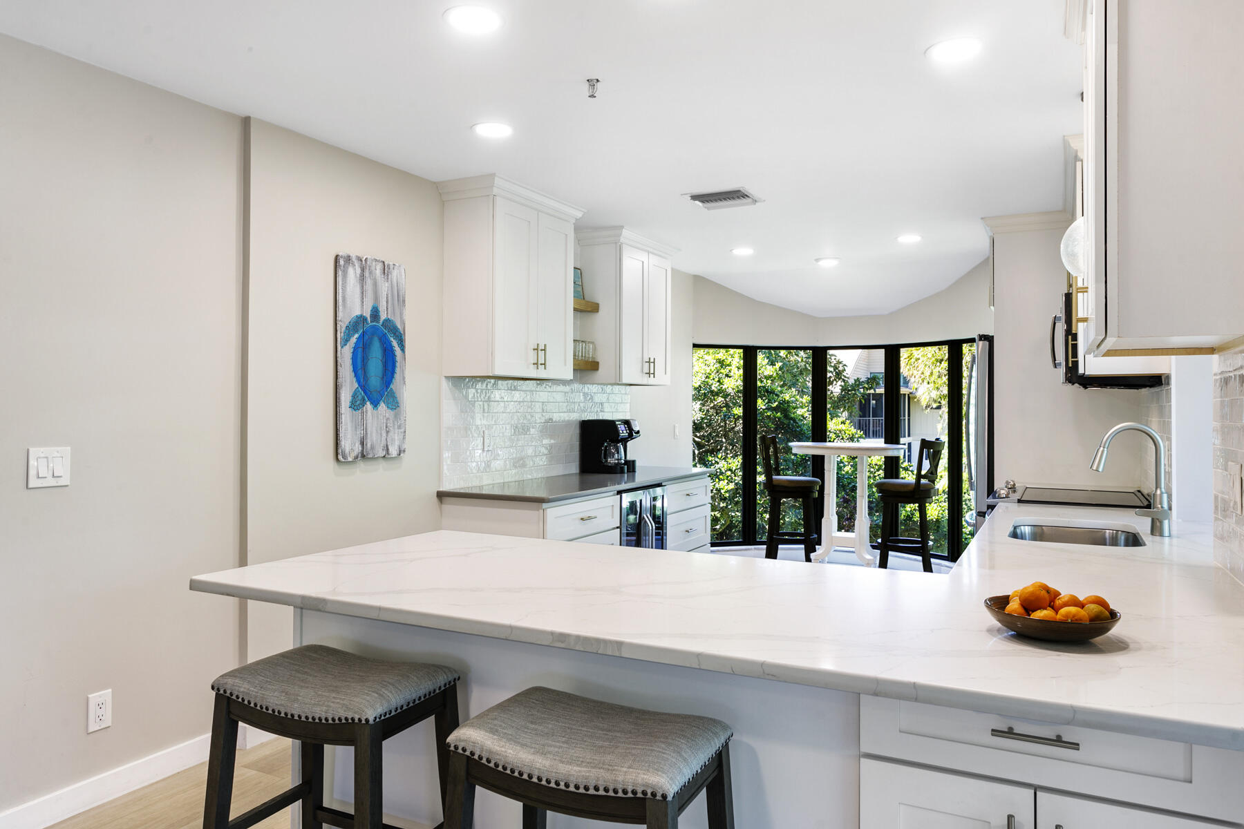17137 Waterbend Drive, Unit 201 Jupiter, FL 33477 - Photo 14 of 43 a kitchen with stainless steel appliances a dining table chairs and a refrigerator