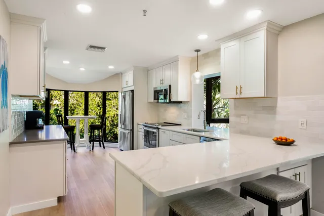 a kitchen with stainless steel appliances a sink and cabinets