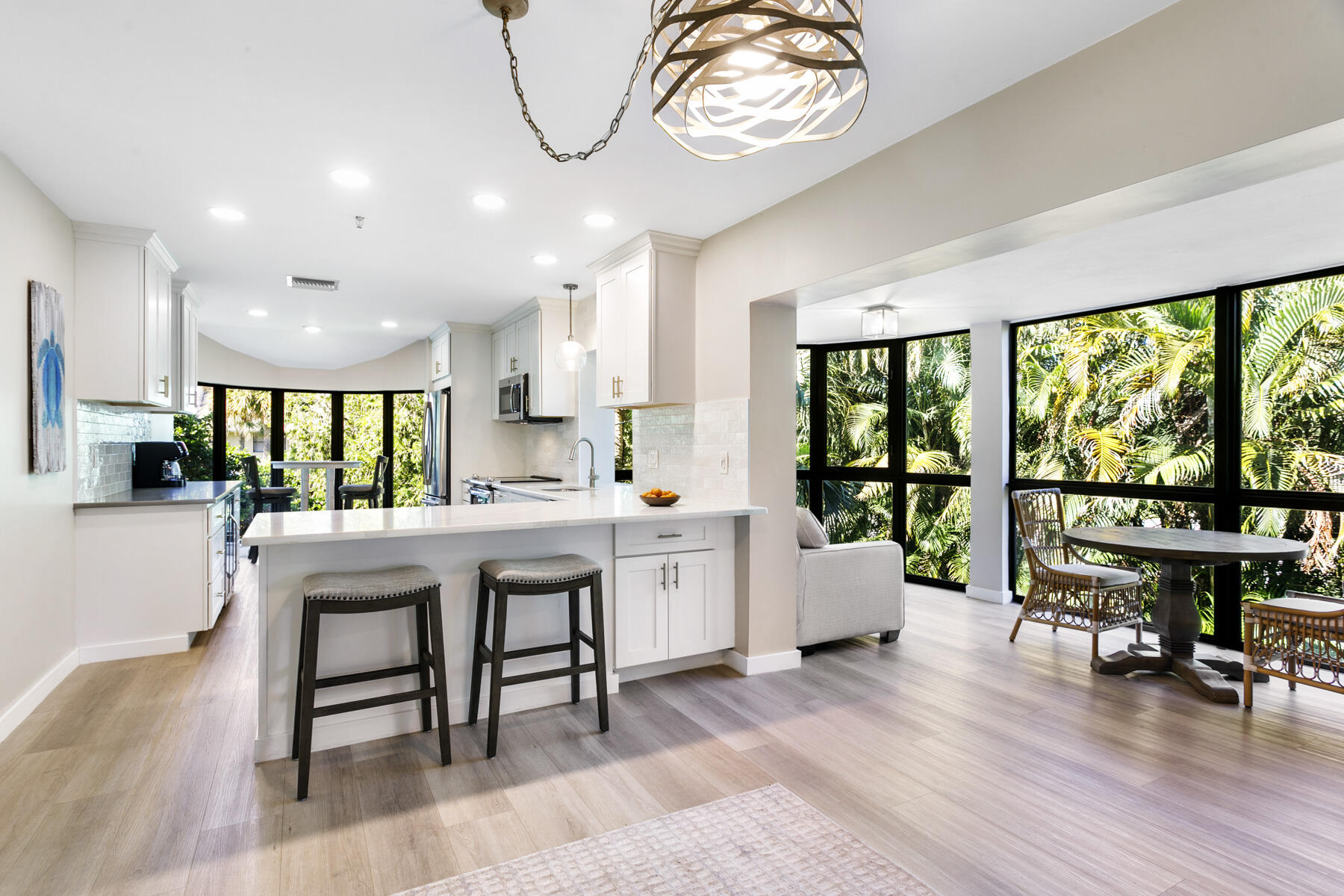 17137 Waterbend Drive, Unit 201 Jupiter, FL 33477 - Photo 18 of 43 a kitchen with a table chairs stove and wooden floor