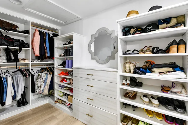 a bathroom with a granite countertop double vanity sink and a mirror