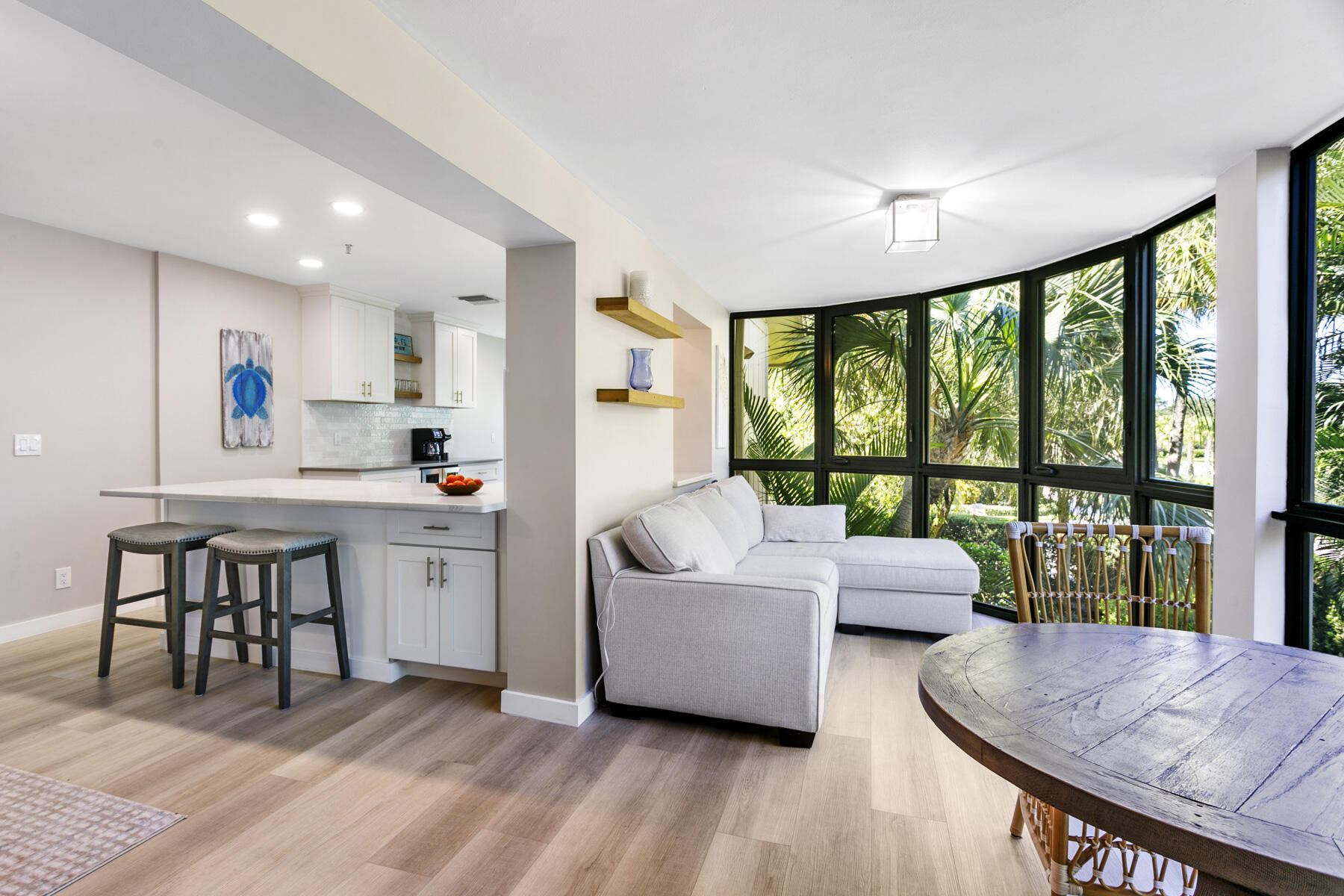 17137 Waterbend Drive, Unit 201 Jupiter, FL 33477 - Photo 8 of 43 a living room with furniture and a large window