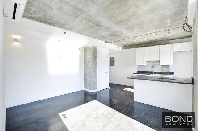 a kitchen with granite countertop a sink and a stove top oven