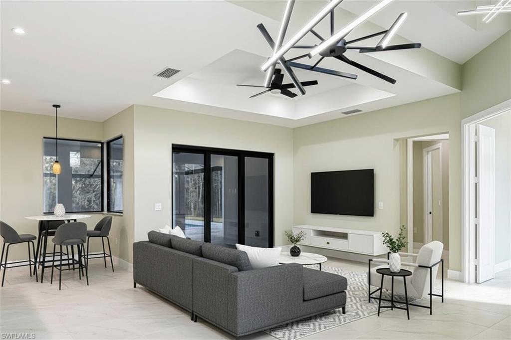 219 33rd Avenue Northwest Naples, FL 34120 - Photo 11 of 41 a living room with furniture and a flat screen tv