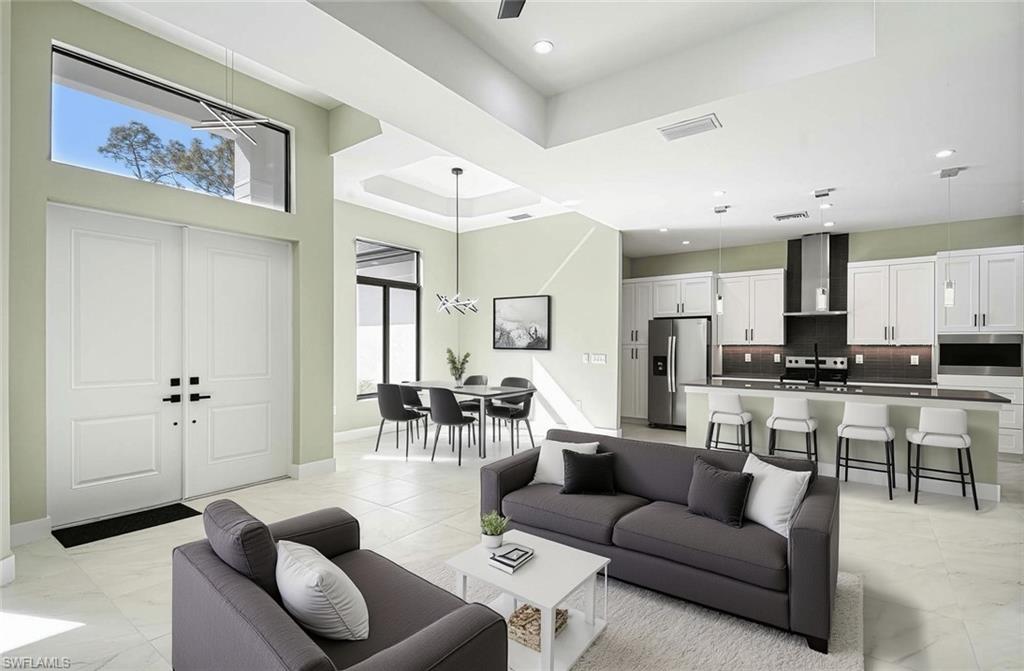 219 33rd Avenue Northwest Naples, FL 34120 - Photo 41 of 41 a living room with furniture white walls and kitchen view