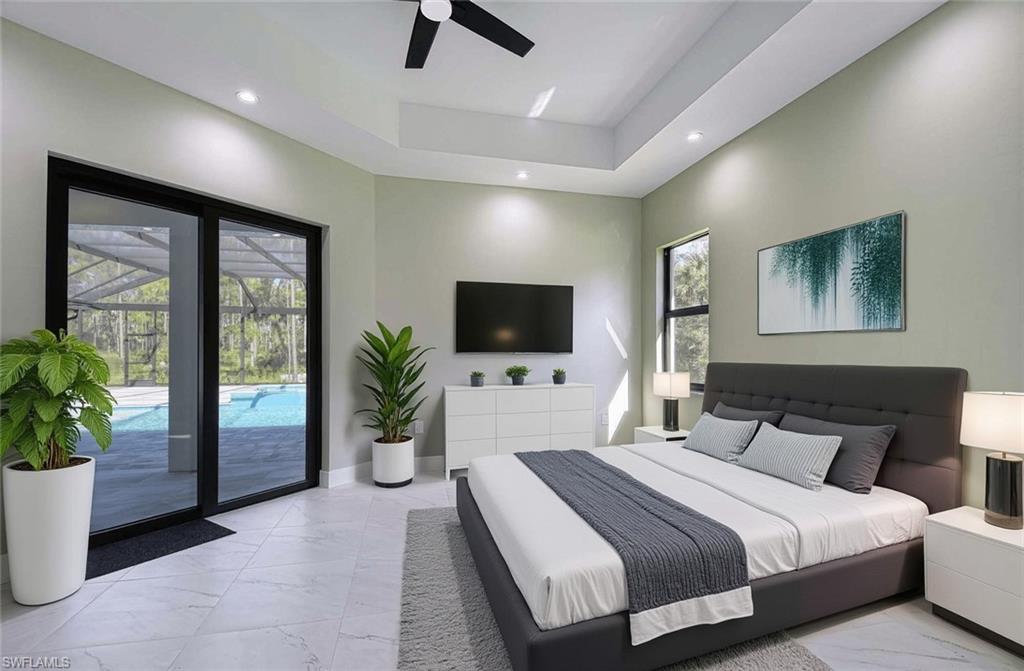 219 33rd Avenue Northwest Naples, FL 34120 - Photo 16 of 41 a bedroom with a bed and a flat screen tv