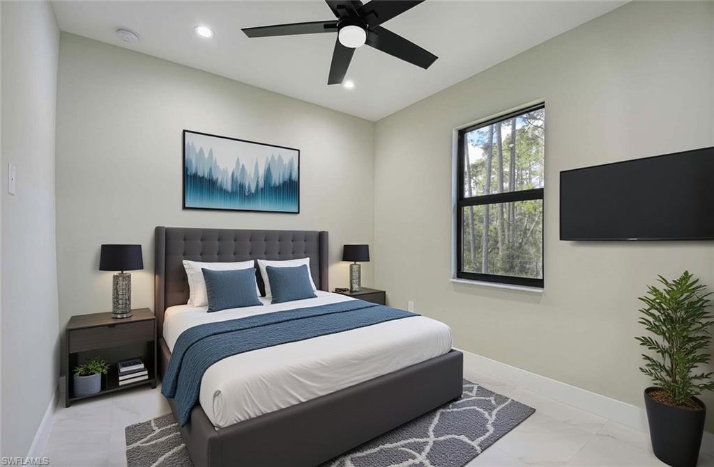 219 33rd Avenue Northwest Naples, FL 34120 - Photo 25 of 41 a bedroom with bed tv and window
