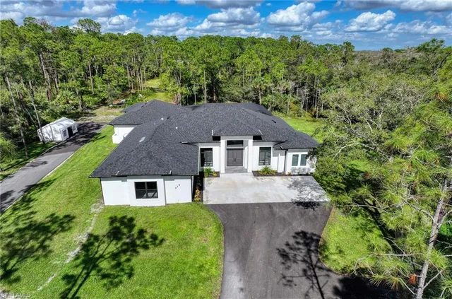 an aerial view of a house with a yard