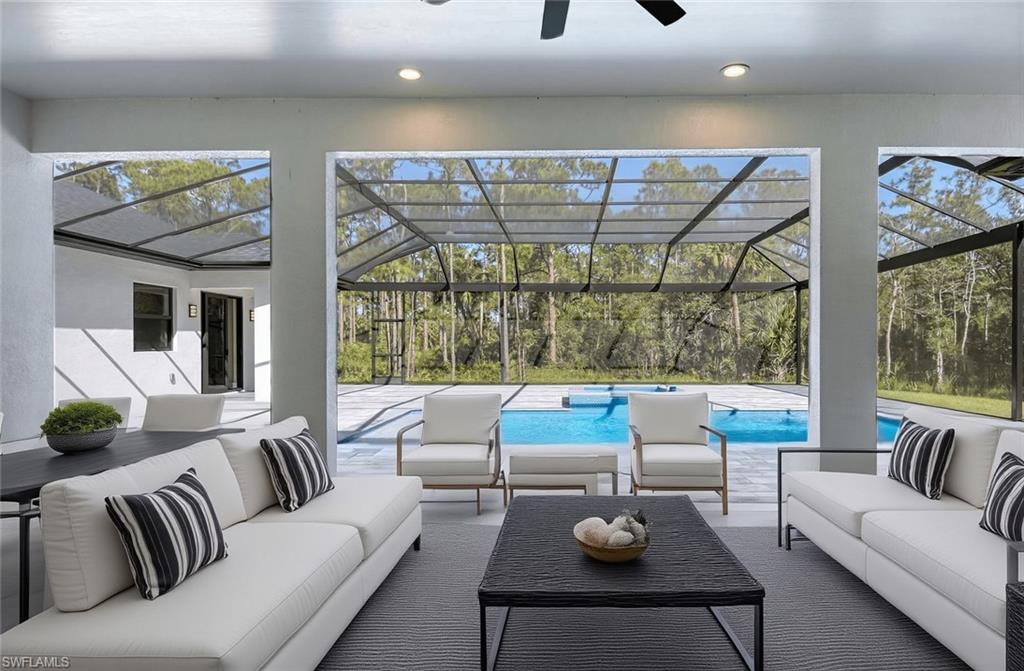 219 33rd Avenue Northwest Naples, FL 34120 - Photo 9 of 41 a living room with furniture and a large window