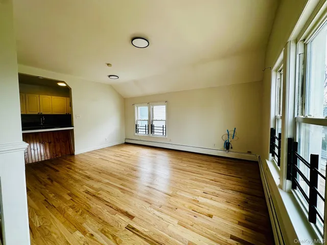 a view of a livingroom with wooden floor and a flat screen tv