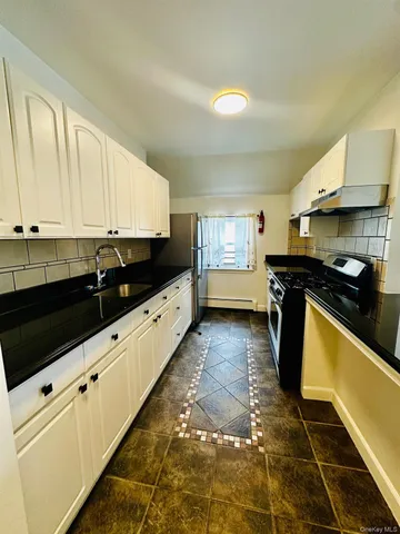 a kitchen with granite countertop a stove a sink and a granite counter tops