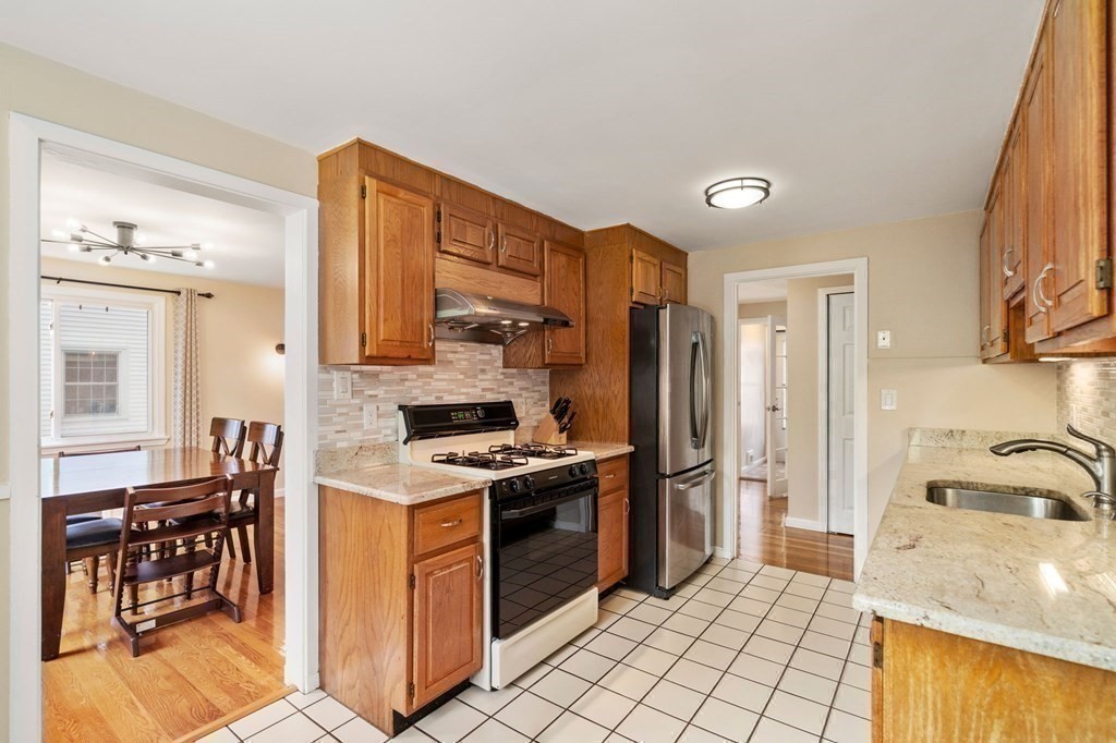 92 Oakdale Road Newton, MA 02459 - Photo 7 of 21 a kitchen with stainless steel appliances granite countertop a stove a sink and a refrigerator