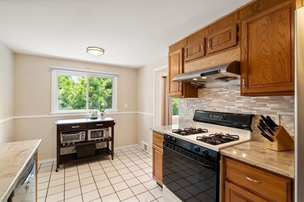 92 Oakdale Road Newton, MA 02459 - Photo 8 of 21 a kitchen with a stove a sink and a microwave