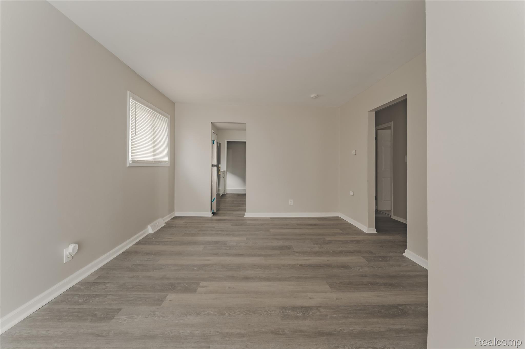 93 West Princeton Avenue Pontiac, MI 48340 - Photo 5 of 31 Spacious interior featuring neutral wall tones, wood-finish flooring, and white baseboards