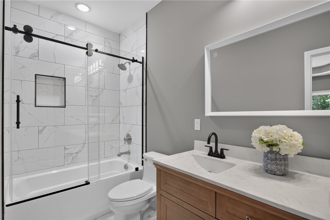 223 Maple Drive Anderson, SC 29621 - Photo 21 of 45 A refined bathroom featuring a contemporary vanity and a tub-shower combination with sleek tile.