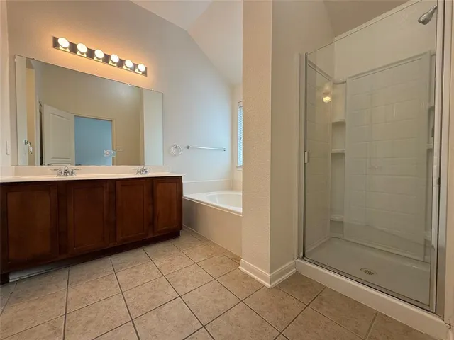 a bathroom with a mirror a sink and a shower