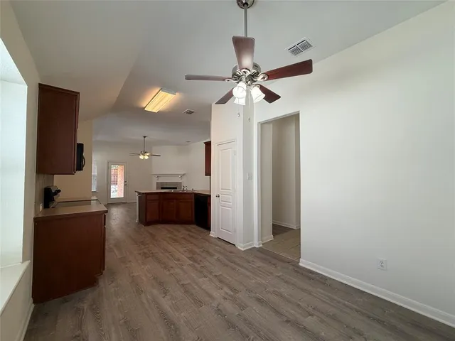 a view of a kitchen with a sink and a refrigerator