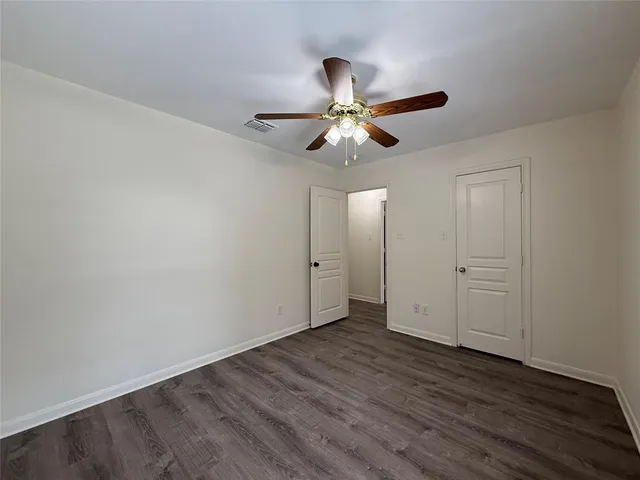 a view of an empty room and wooden floor