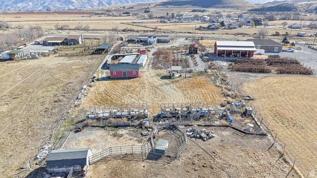718 South State Street Genola, UT 84655 - Photo 12 of 19 Expansive rural property featuring multiple structures, including a prominent red barn with a white roof