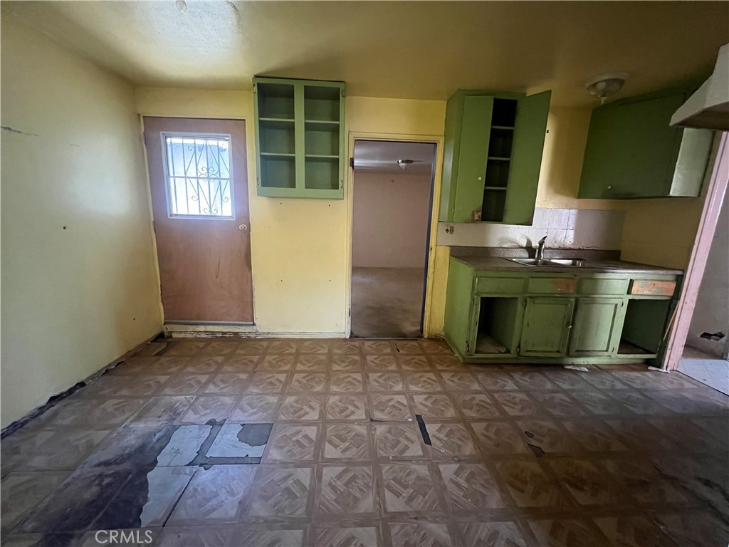 6942 Watcher Street Commerce, CA 90040 - Photo 7 of 14 an empty room with a fireplace and windows
