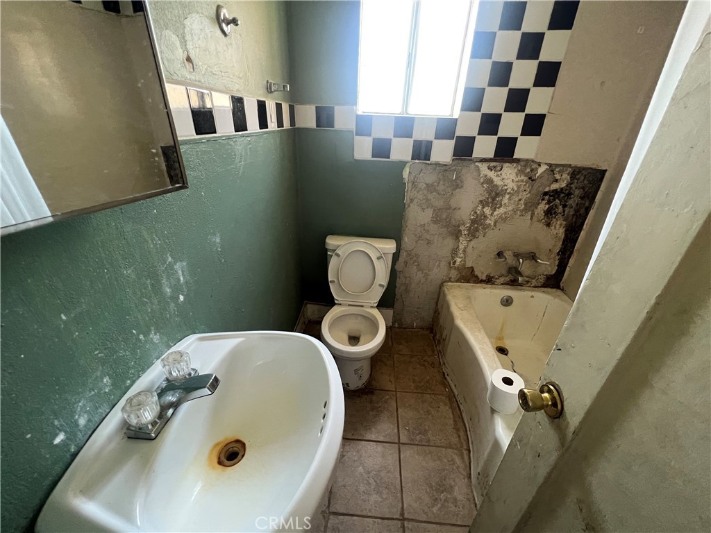 6942 Watcher Street Commerce, CA 90040 - Photo 9 of 14 a bathroom with a sink and toilet