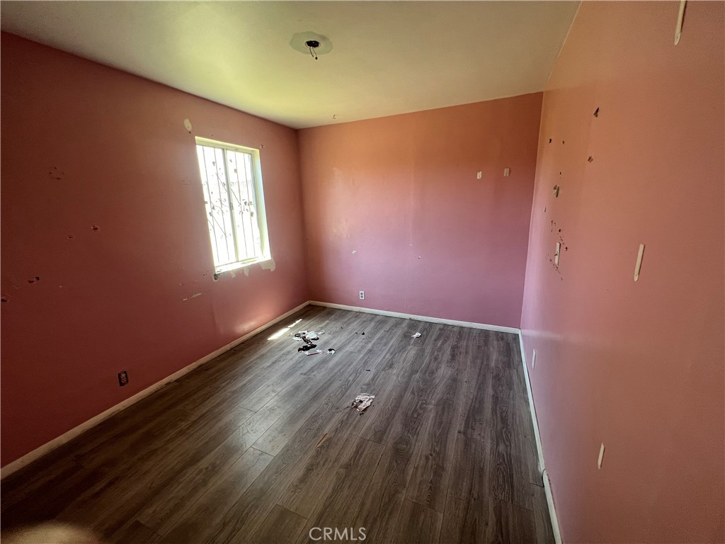 6942 Watcher Street Commerce, CA 90040 - Photo 10 of 14 an empty room with wooden floor and windows