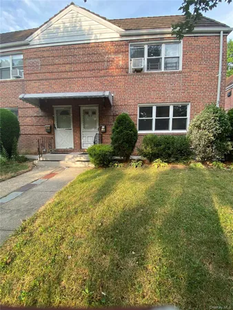 a front view of a house with yard and outdoor seating