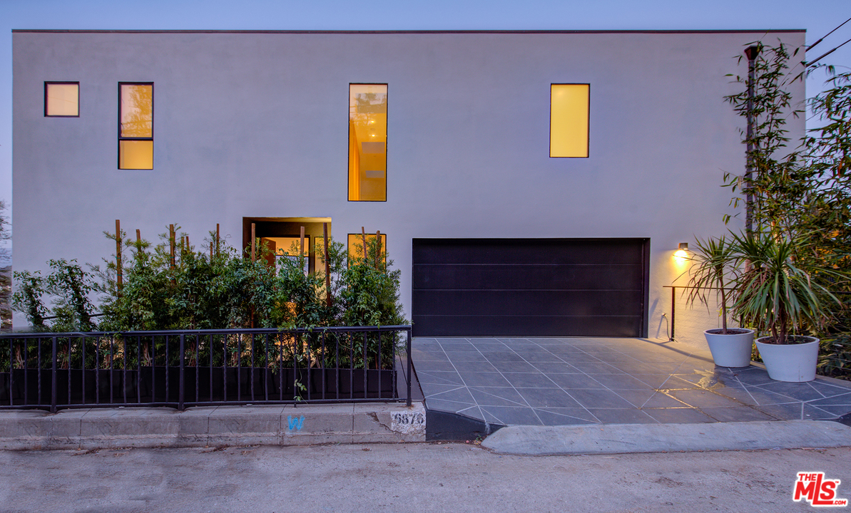 6876 Pacific View Drive Los Angeles, CA 90068 - Photo 2 of 31 a front view of a house with a fence