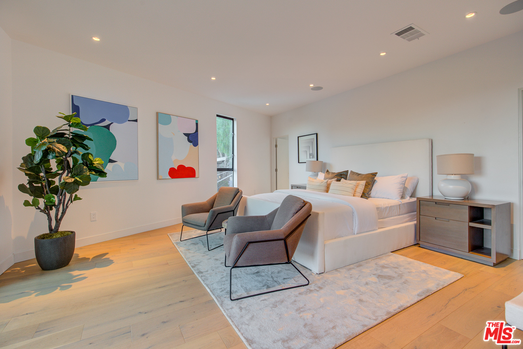 6876 Pacific View Drive Los Angeles, CA 90068 - Photo 16 of 31 a living room with furniture potted plant and a table