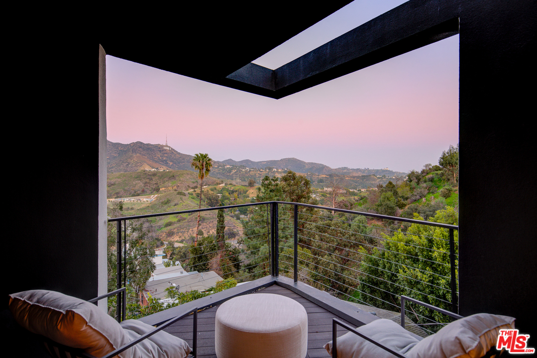 6876 Pacific View Drive Los Angeles, CA 90068 - Photo 18 of 31 a view of a balcony with chair and wooden floor