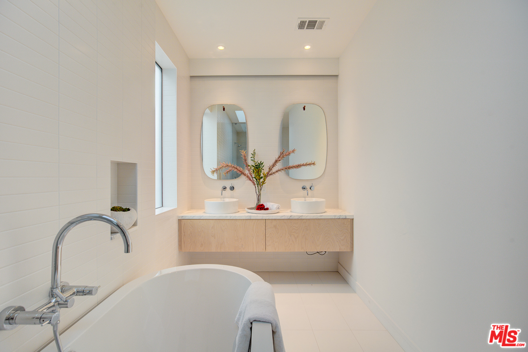 6876 Pacific View Drive Los Angeles, CA 90068 - Photo 19 of 31 a bathroom with a sink and a mirror