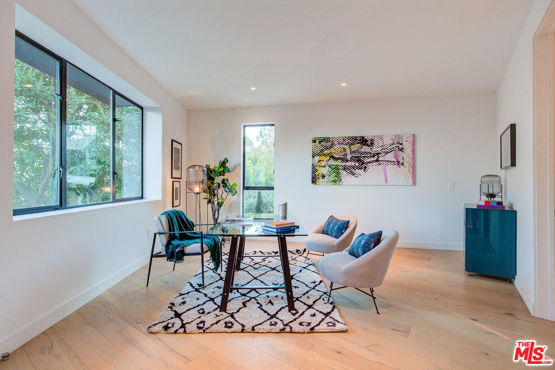 6876 Pacific View Drive Los Angeles, CA 90068 - Photo 20 of 31 a living room with furniture and a potted plant