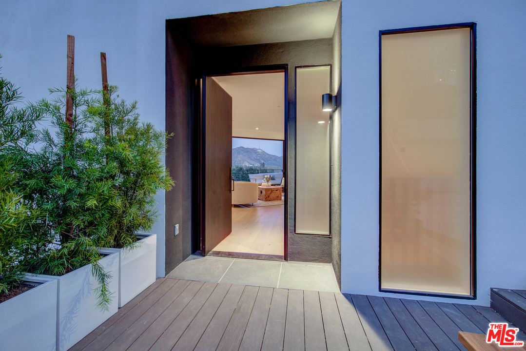6876 Pacific View Drive Los Angeles, CA 90068 - Photo 3 of 31 a view of a balcony with wooden floor and fence