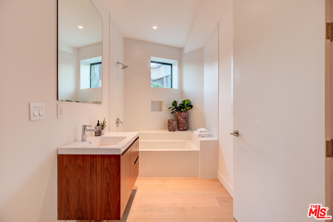 6876 Pacific View Drive Los Angeles, CA 90068 - Photo 21 of 31 a bathroom with a sink a bathtub and a mirror