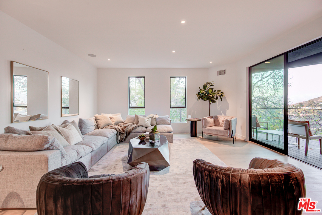 6876 Pacific View Drive Los Angeles, CA 90068 - Photo 24 of 31 a living room with furniture and a large window