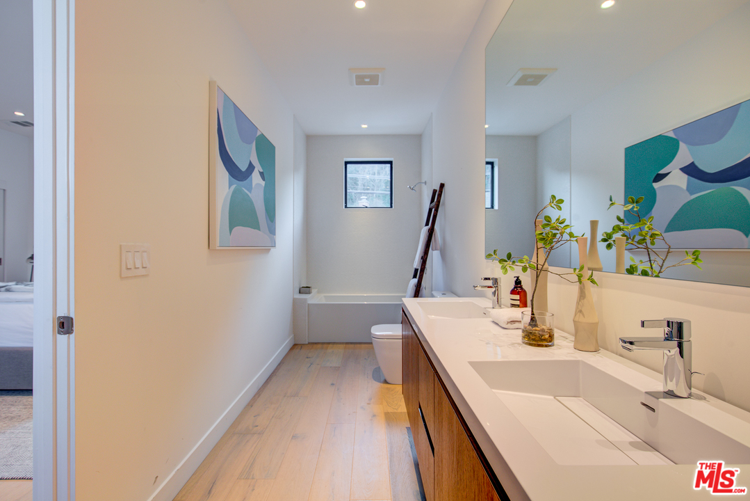 6876 Pacific View Drive Los Angeles, CA 90068 - Photo 26 of 31 a bathroom with a sink and a large mirror
