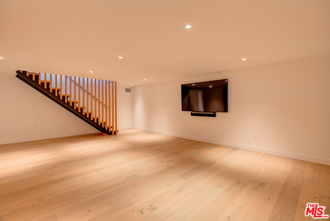 6876 Pacific View Drive Los Angeles, CA 90068 - Photo 29 of 31 a view of a livingroom with wooden floor and stairs