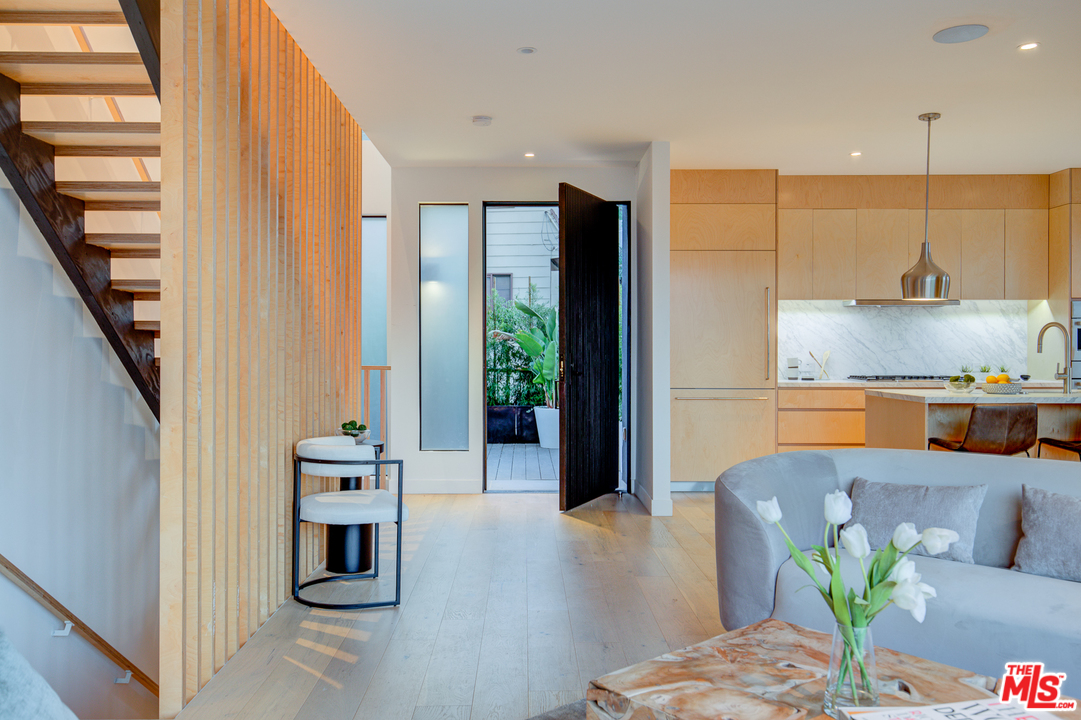 6876 Pacific View Drive Los Angeles, CA 90068 - Photo 4 of 31 a kitchen with stainless steel appliances kitchen island granite countertop a refrigerator a stove and a wooden cabinets
