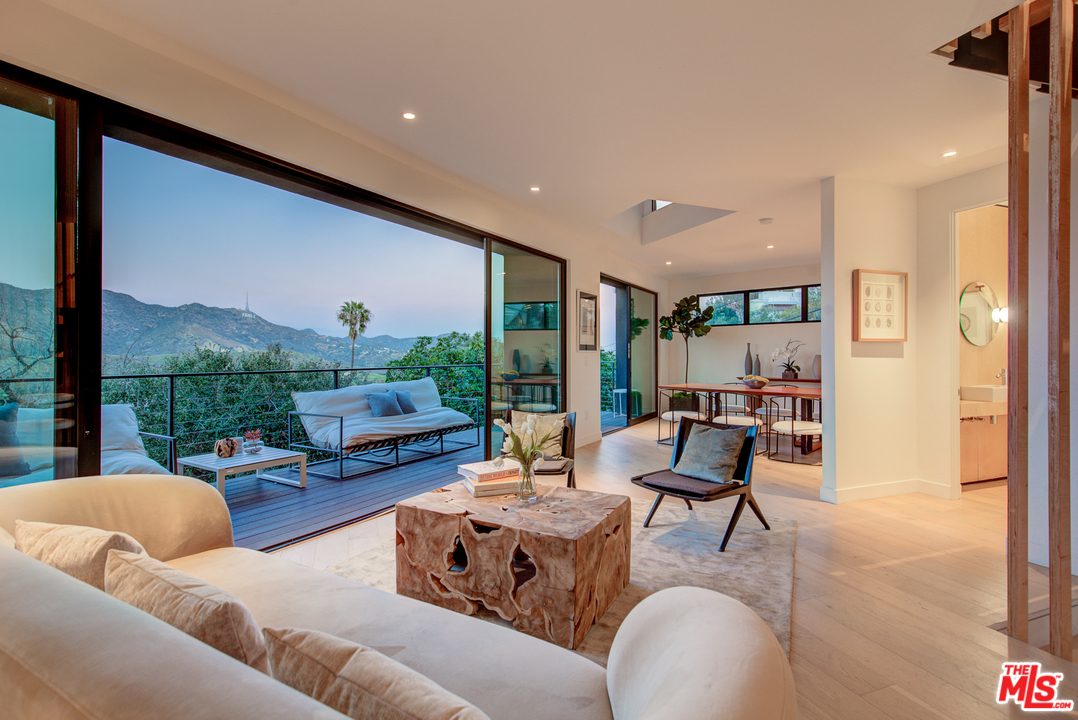 6876 Pacific View Drive Los Angeles, CA 90068 - Photo 10 of 31 a living room with furniture and a large window